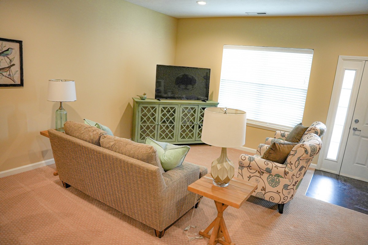 Cozy living room with comfortable seating and a TV.