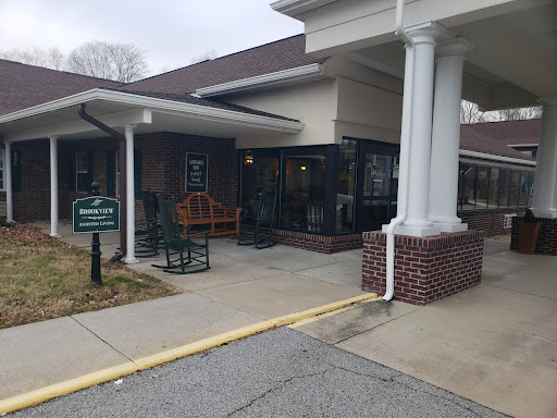 A view of the entrance to a restaurant with outdoor seating.