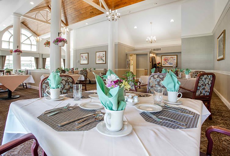 An elegantly set dining table in a well-decorated restaurant interior.