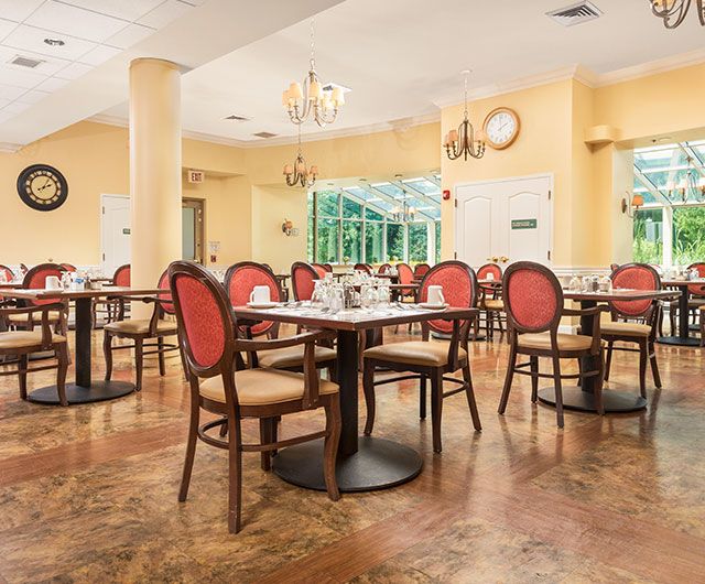 An elegant dining room with neatly arranged tables and chairs.