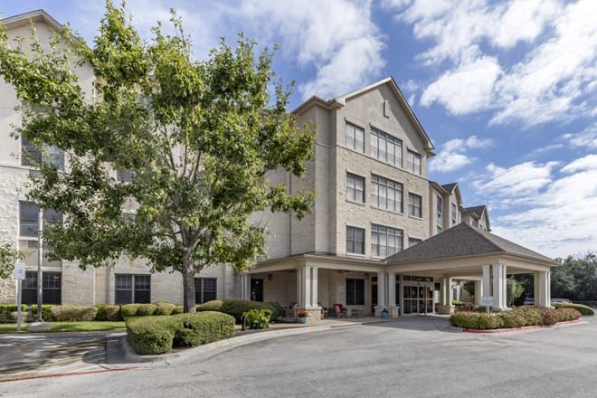 A mid-sized hotel with a welcoming entrance and landscaped surroundings.
