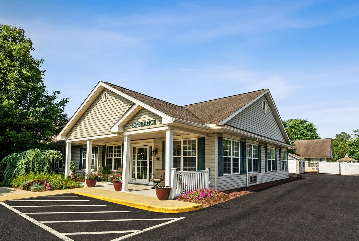 A small office building with a paved parking area in front.
