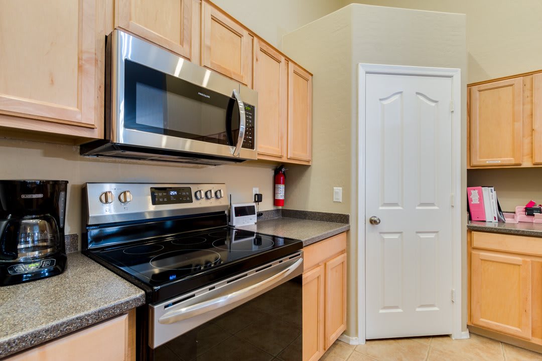 A modern kitchen with stainless steel appliances and wooden cabinets.