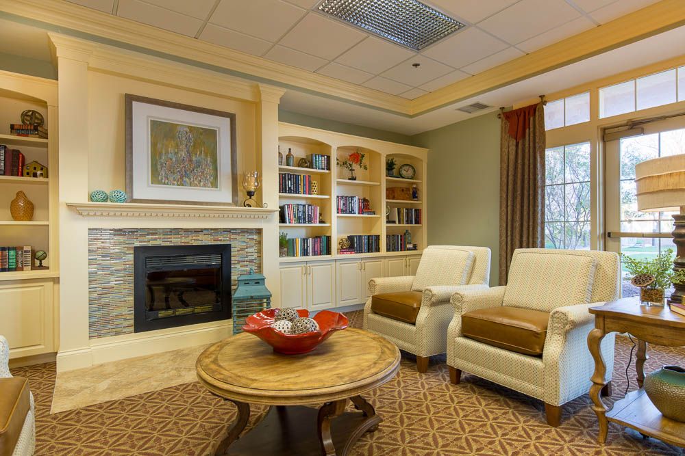 A cozy living room with a fireplace and elegant furnishings.