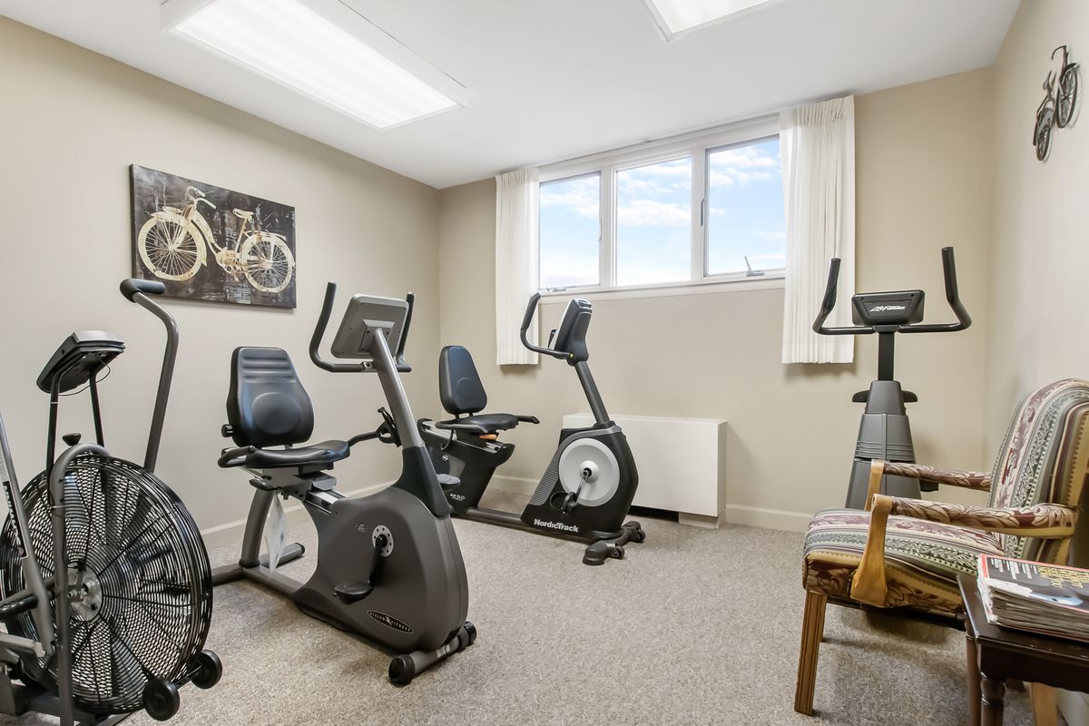 A home gym featuring several exercise bikes for indoor cycling workouts.