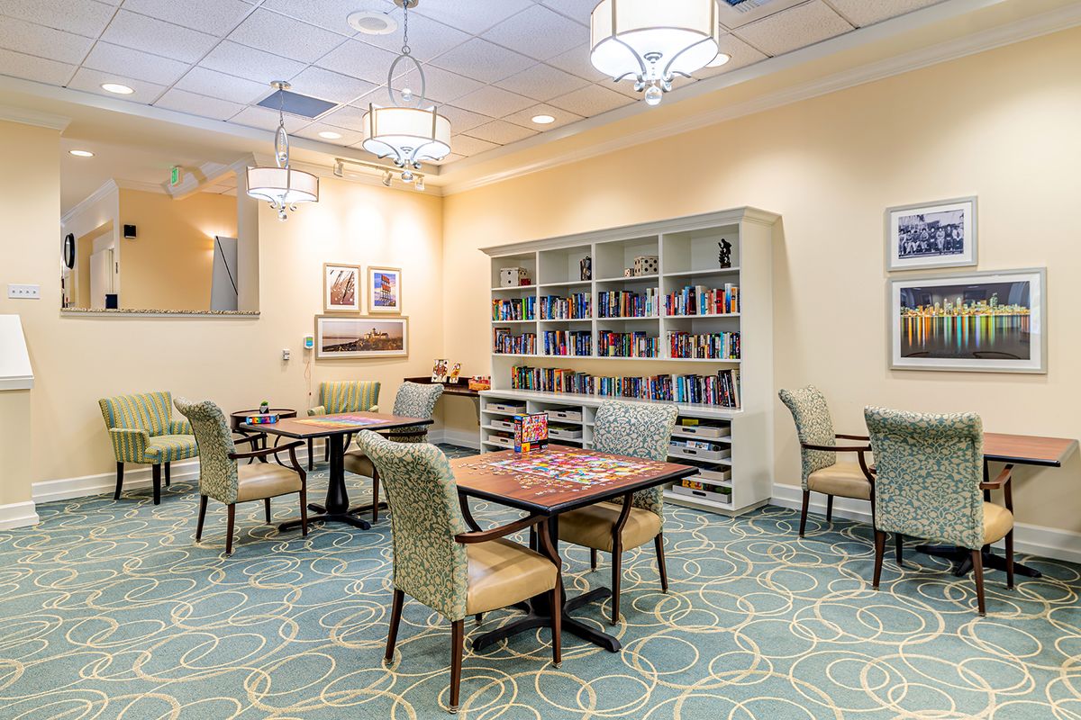 A cozy reading room with bookshelves and comfortable seating.