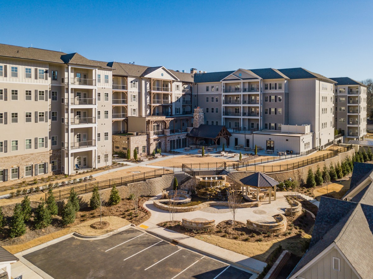 A modern residential apartment complex with landscaped outdoor areas.
