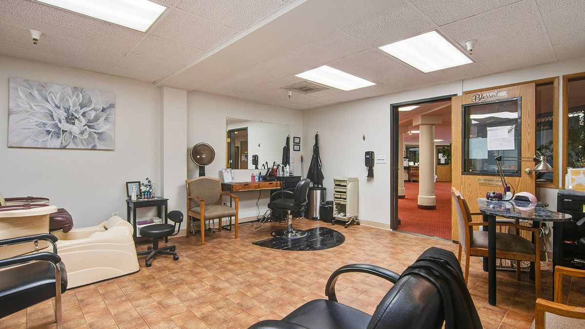 A well-equipped hair salon interior with a styling station, chairs, and mirrors.
