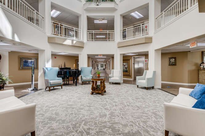 An elegant lobby interior with seating areas and decorative elements.