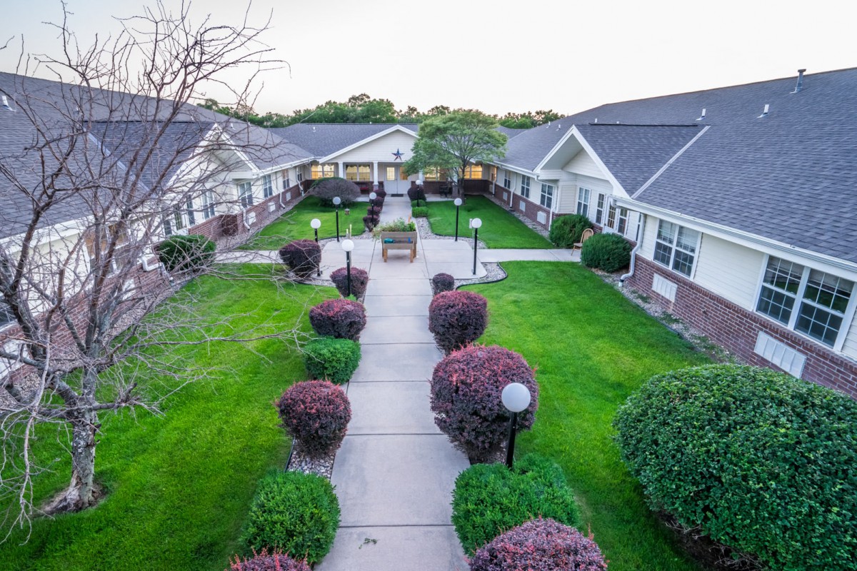 A tranquil courtyard surrounded by well-maintained gardens and residential buildings.