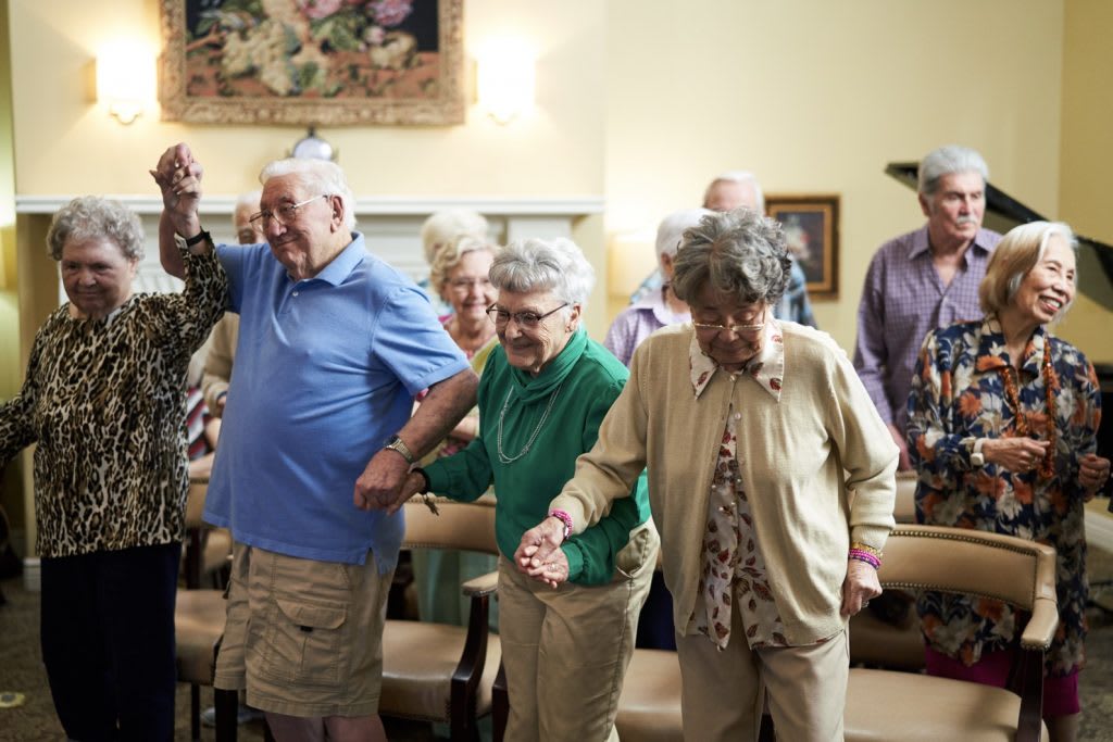 A group of seniors participating in a social activity together, enjoying each other's company.