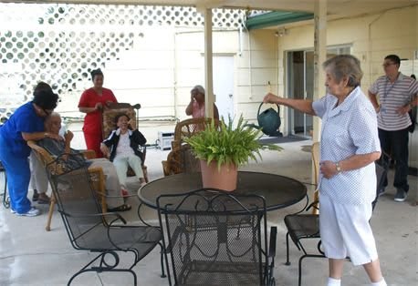 A group of people gathered on a patio enjoying each other's company.