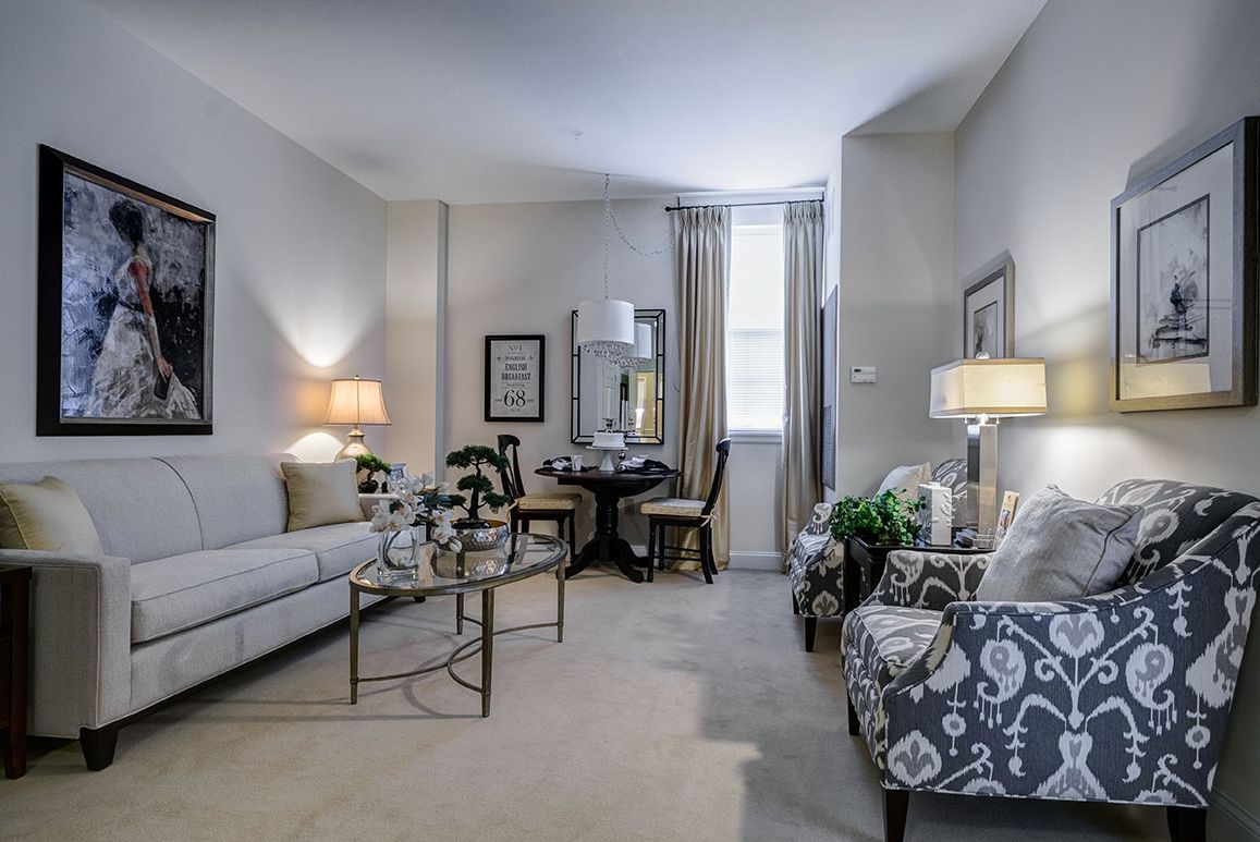 A cozy and elegantly designed living room with comfortable seating, stylish lamps, and tasteful decor.