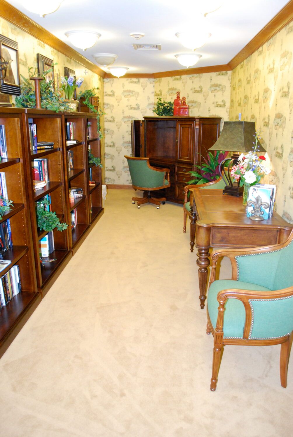 A cozy library nook with wooden bookshelves, armchairs, and decorative elements.