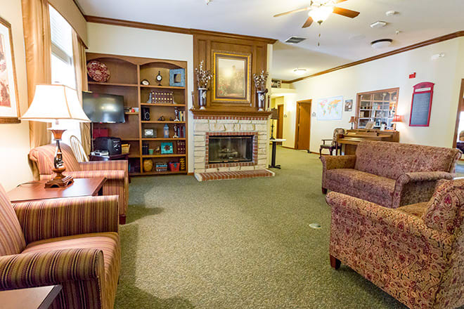 A cozy living room with a fireplace and comfortable seating.