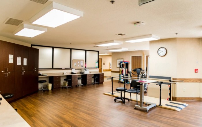A well-equipped physical therapy room with modern exercise equipment.