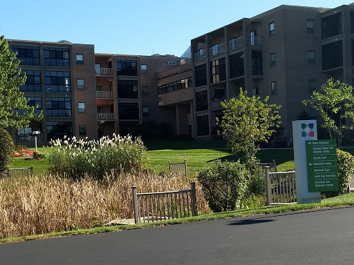 A view of a residential building surrounded by greenery.
