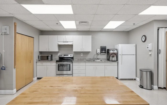 A modern kitchen with various appliances including a refrigerator, oven, and microwave.