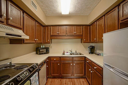 A cozy kitchen featuring wooden cabinets and modern appliances.