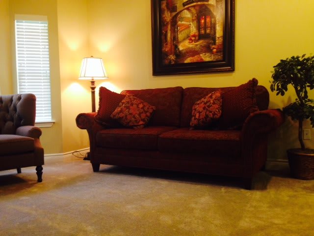 A cozy living room with a plush sofa, warm lighting, and elegant decor.
