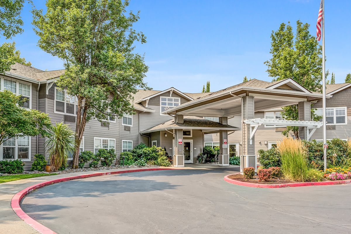 A welcoming entrance of a residential building with landscaped surroundings.