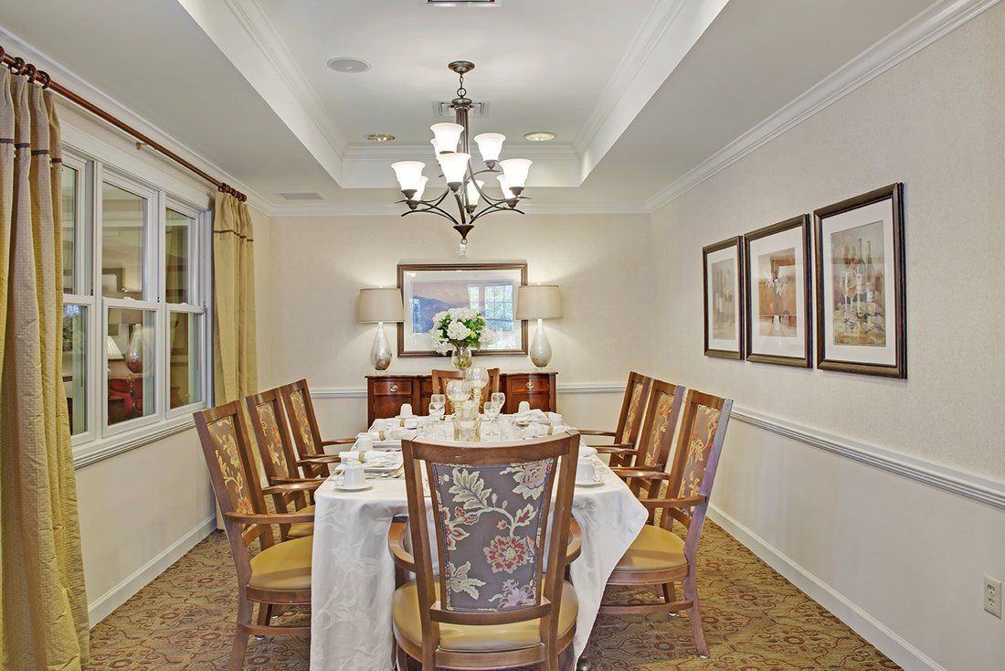 A well-decorated dining room with a large table set for a meal.