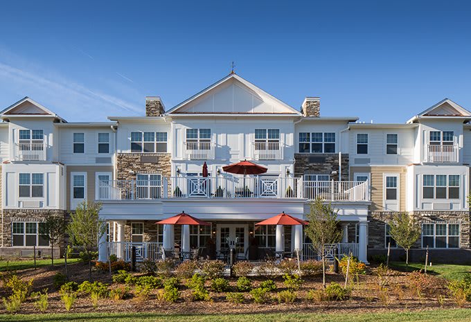 A modern residential building with balconies and well-maintained landscaping.
