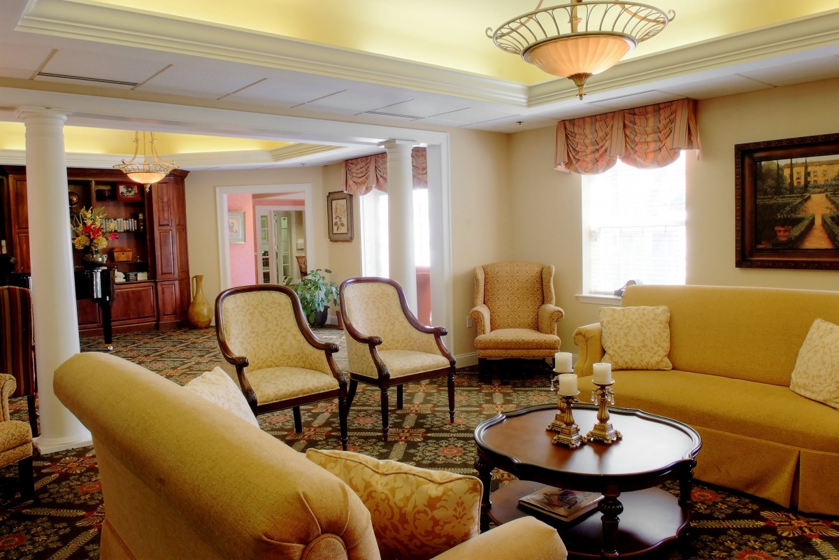 A cozy living room with comfortable seating and elegant chandeliers.
