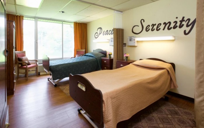 A calming hospital room with two neatly made beds, creating a serene and peaceful atmosphere.