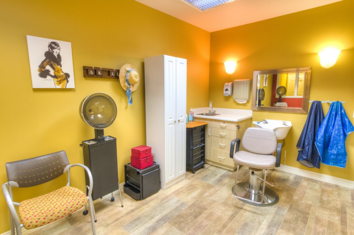 An inviting hair salon interior with a barber chair, sink, and wall decor.