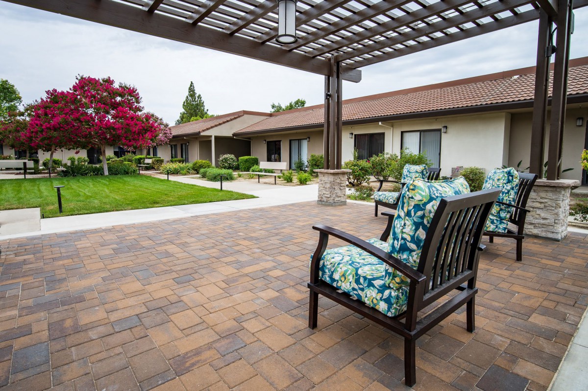 A tranquil courtyard with outdoor seating and lush landscaping.