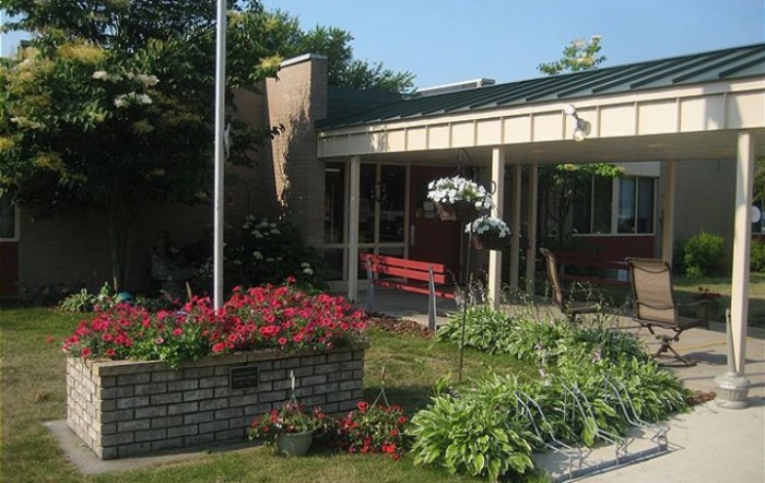 A charming garden with colorful flowers in front of a building.