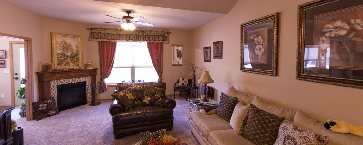 A cozy living room featuring comfortable seating, decorative pillows, and a warm ambiance.