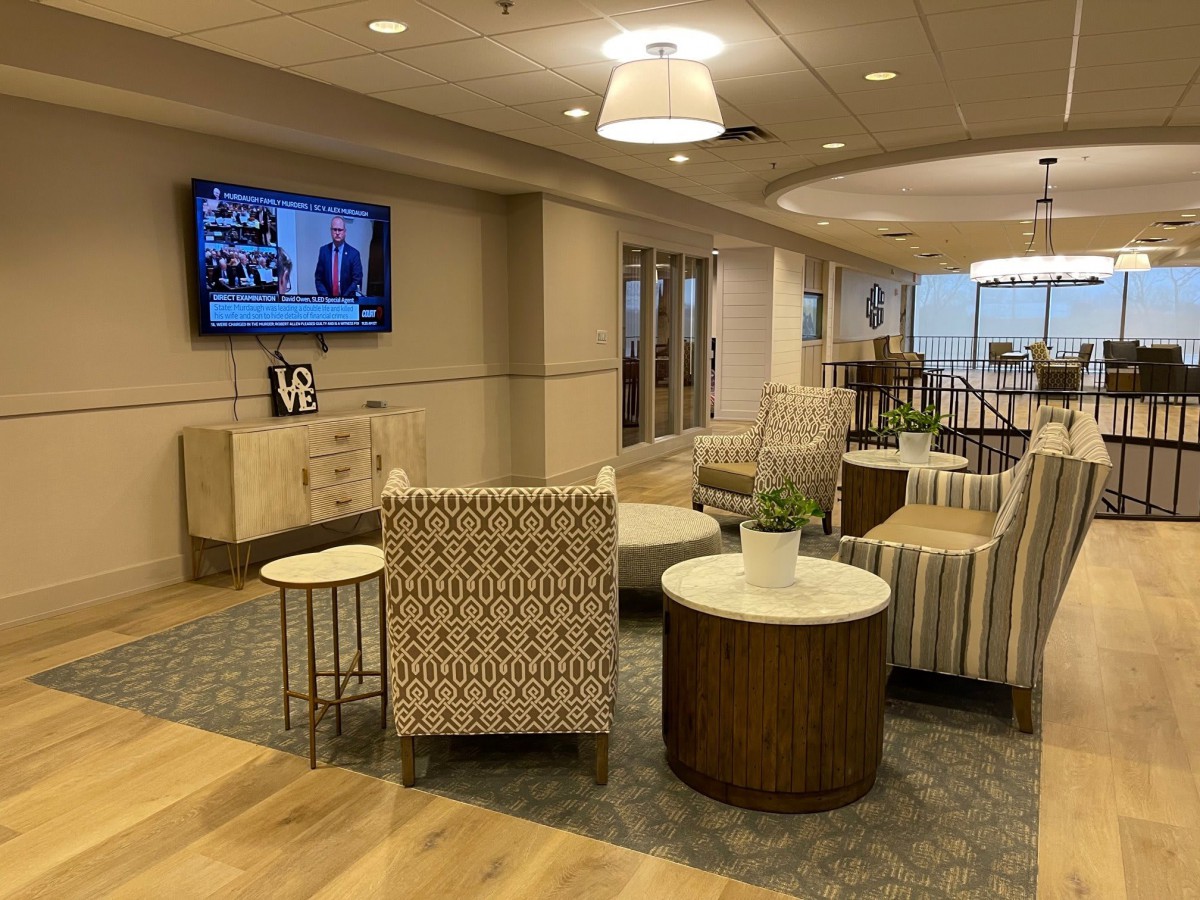 A modern lobby with comfortable seating and a television.