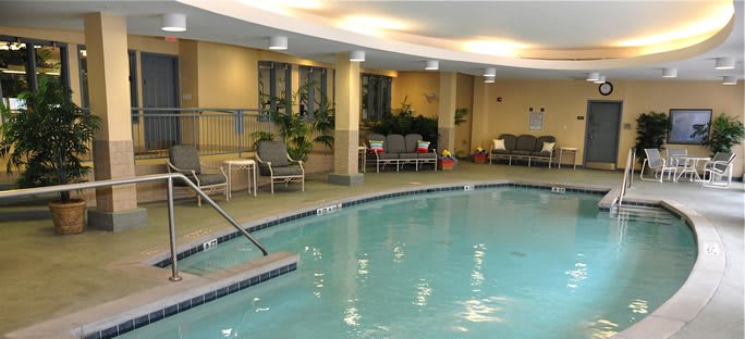 An inviting indoor swimming pool with loungers and a relaxation area.