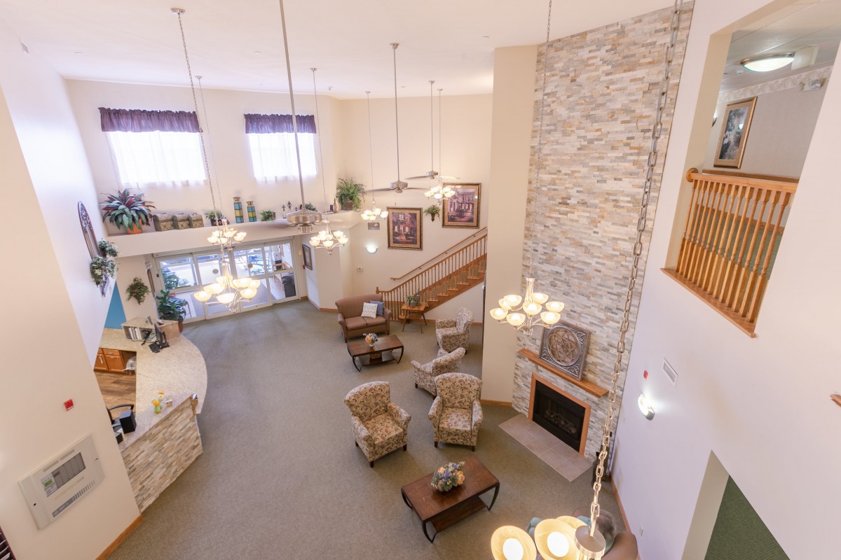 Spacious lobby area with a cozy seating arrangement and a stone fireplace.