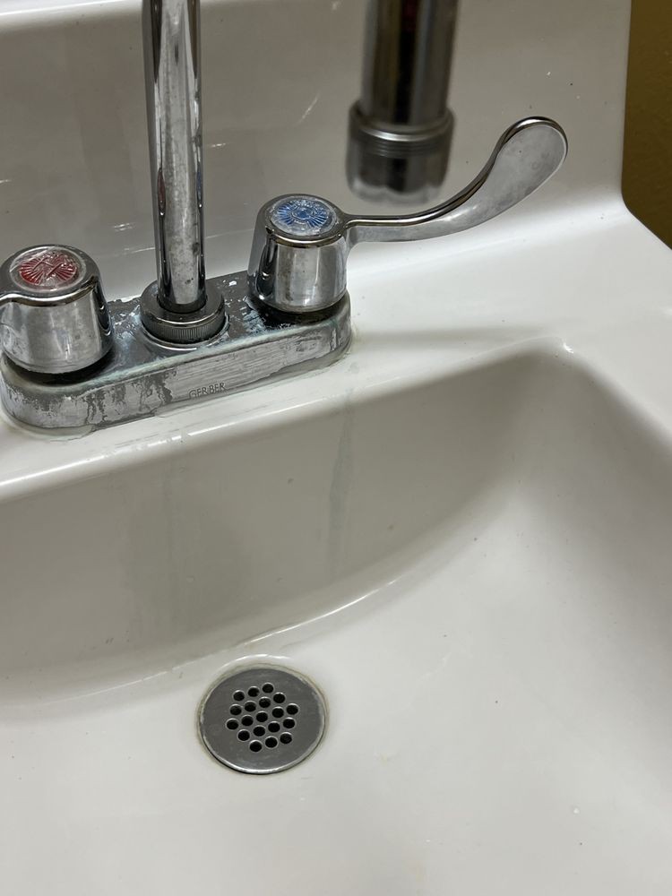 A bathroom sink with separate hot and cold water taps.