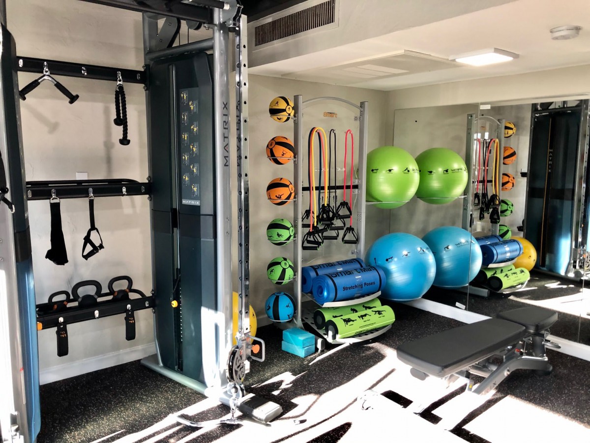 A well-equipped gym with various exercise tools and fitness equipment.