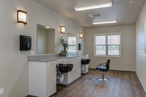 A clean and modern salon interior featuring styling stations and mirrors.
