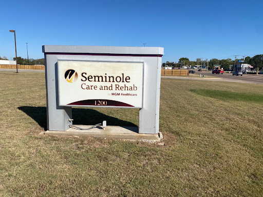 A sign indicating the Seminole Care and Rehabilitation facility in a grassy area.