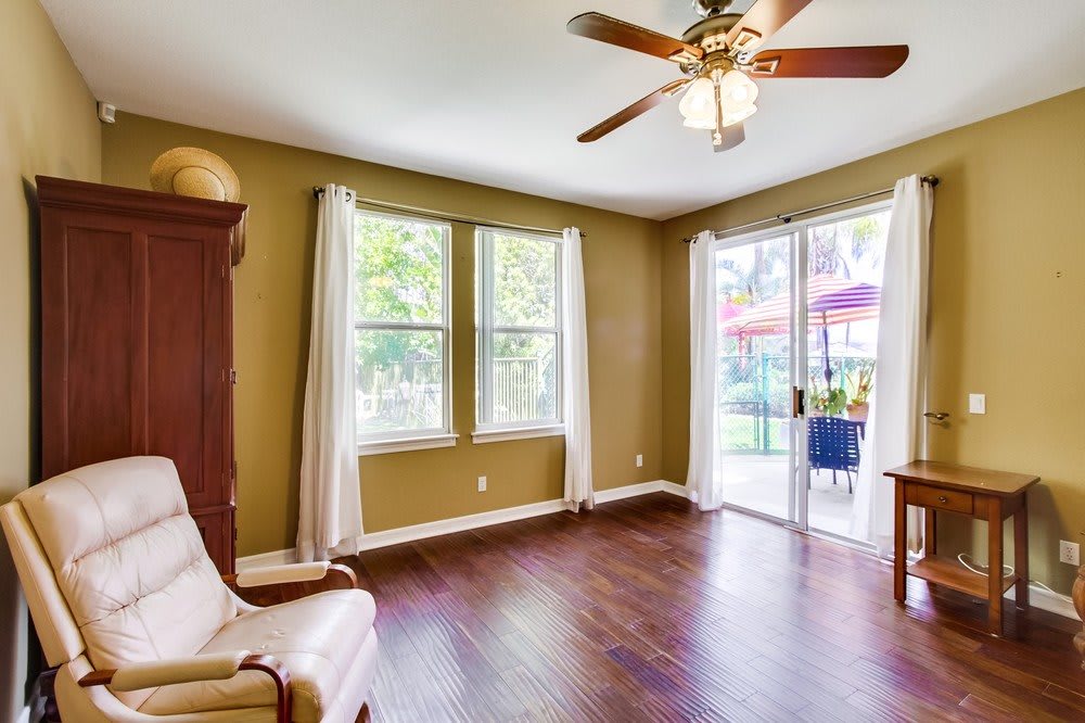 Bright and spacious empty living room with hardwood floors and plenty of natural light.