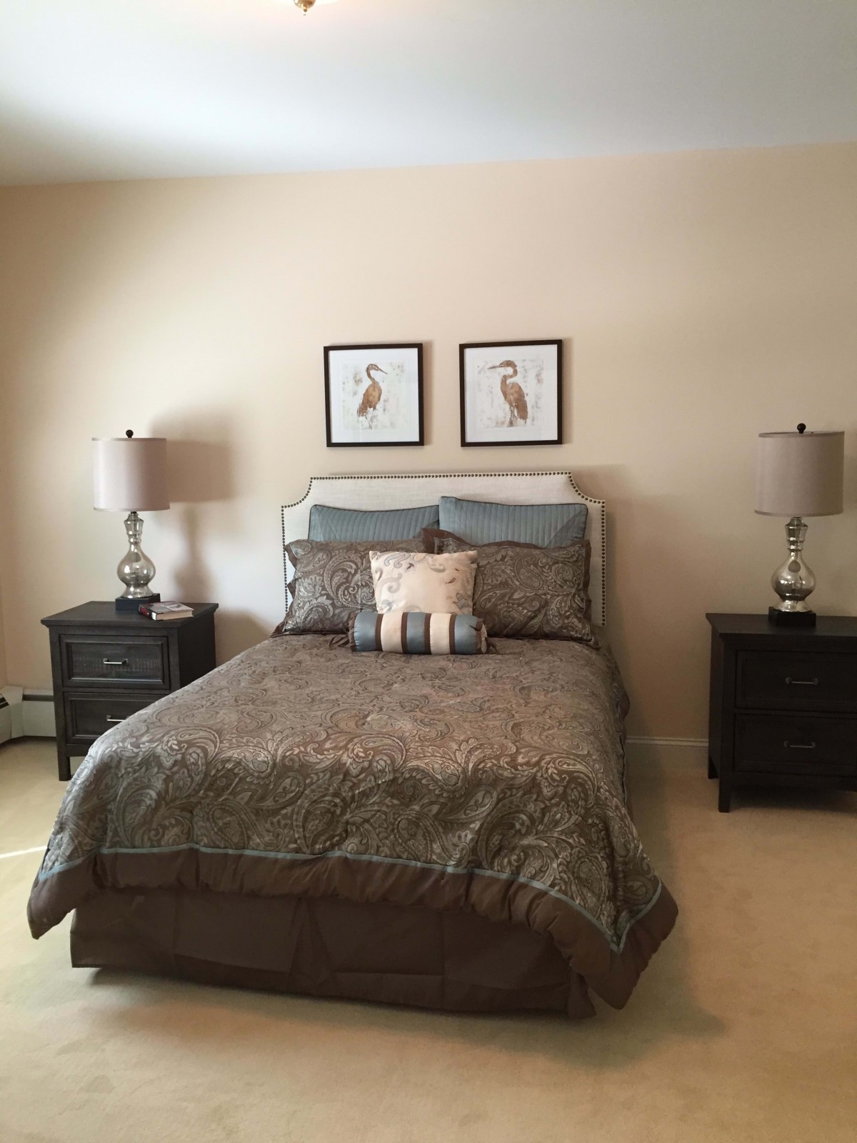 A cozy bedroom with decorative elements and a neatly made bed.