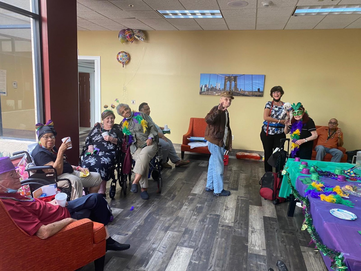 A cheerful gathering with people enjoying a party in a decorated indoor setting.