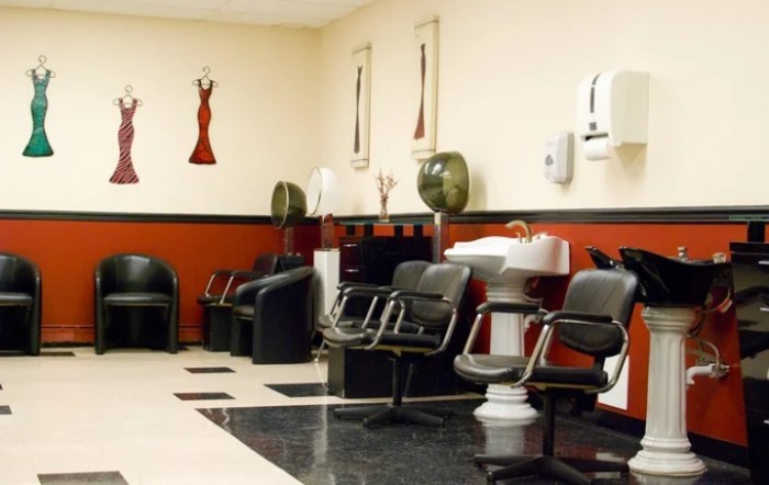Interior of a hair salon with chairs, washing stations, and wall decor.