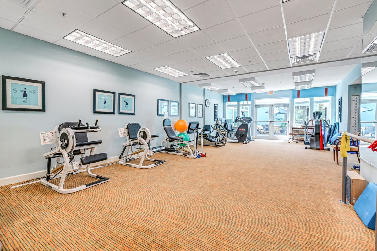 A spacious gym with exercise equipment and workout machines.