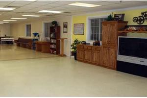 A spacious indoor area featuring wooden kitchen cabinets and ample flooring space.