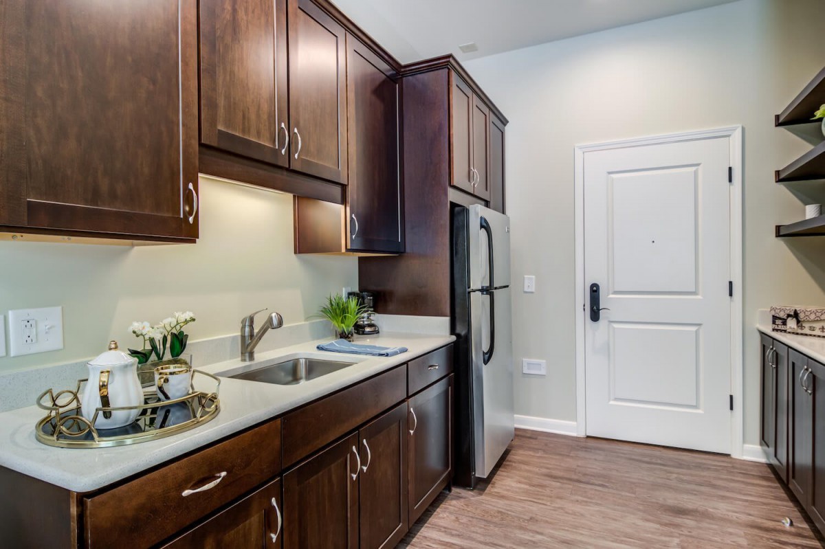 A modern kitchen with wood cabinets and stainless steel appliances.