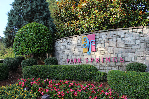 Entrance sign of Park Springs surrounded by beautifully landscaped flowers and greenery.