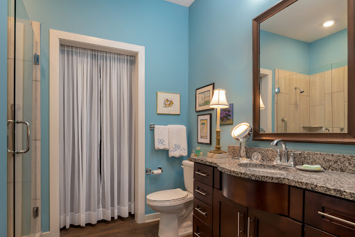 A modern bathroom featuring calming blue walls and elegant fixtures.