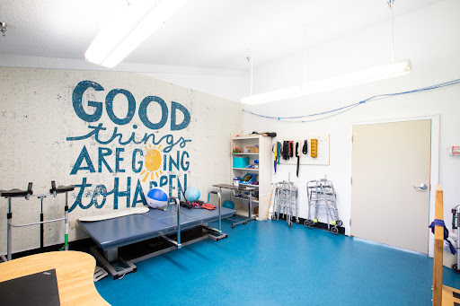A bright and inspiring room with motivational wall art and organized shelves, featuring a blue floor.